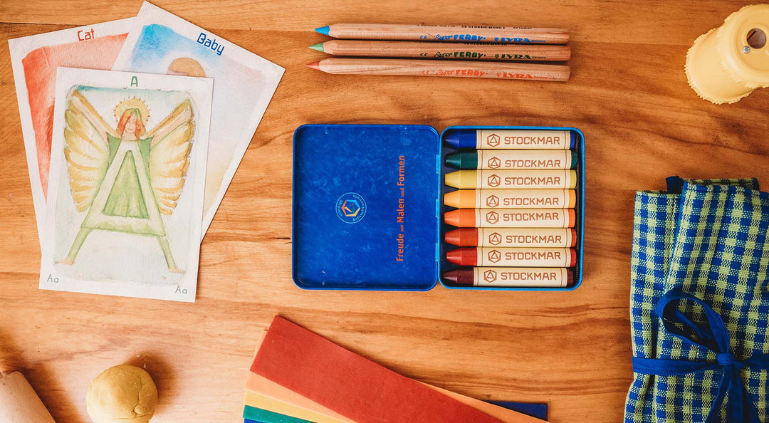 A collection of school items sit on a table.