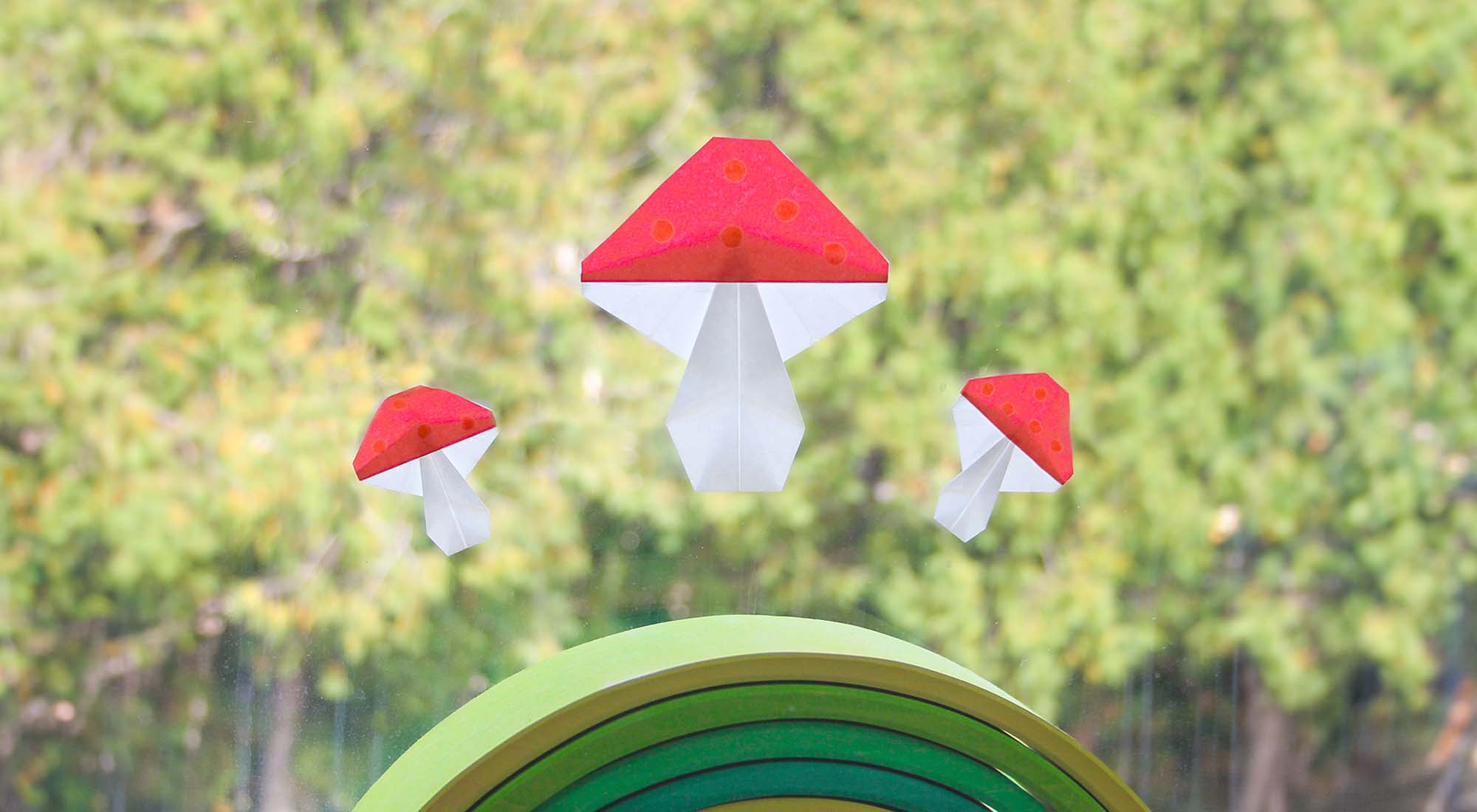 Kite paper mushroom on a window with a Grimm's Green rainbow.