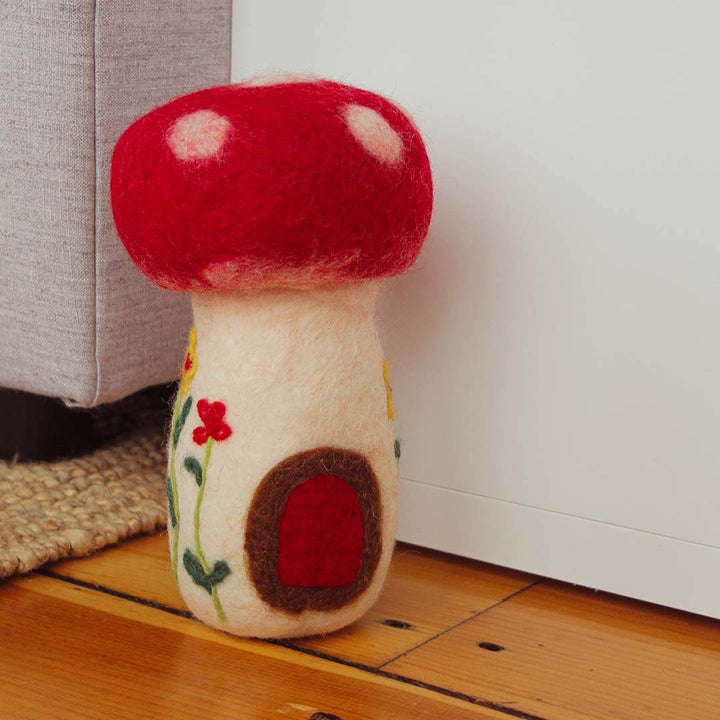 Felted Mushroom on a hardwood floor.