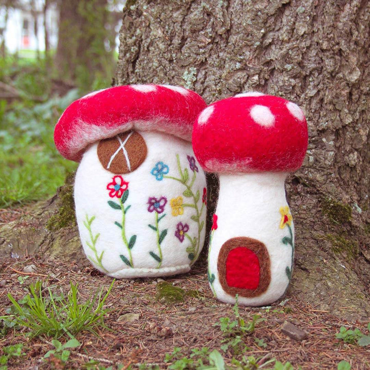 Set Of Two Felted Mushrooms outside next to a tree with grass.