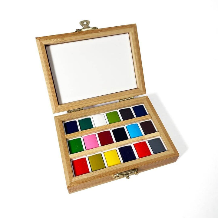 Travel watercolor set in a bamboo case. Contains 18 colors.