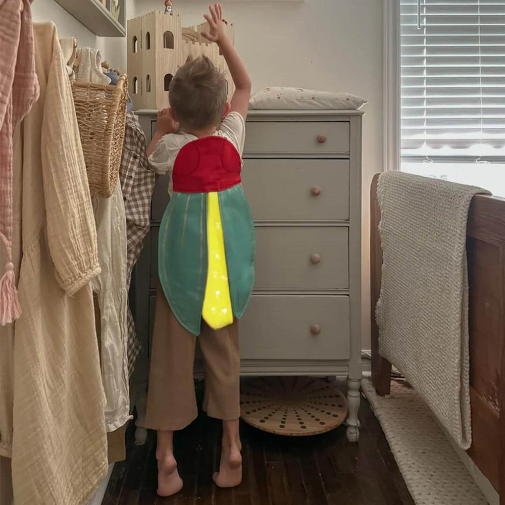 Kid wearing Firefly Costume standing in bedroom