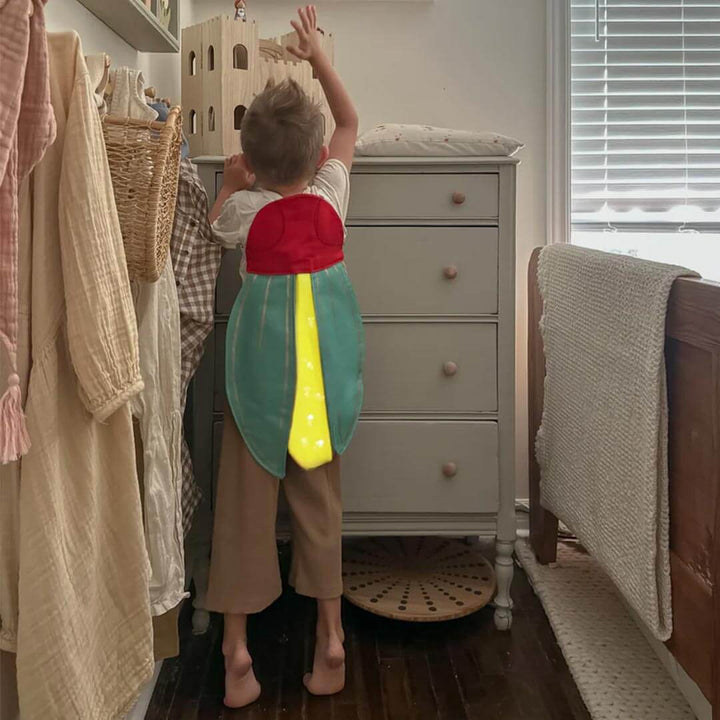 Kid wearing Firefly Costume standing in bedroom