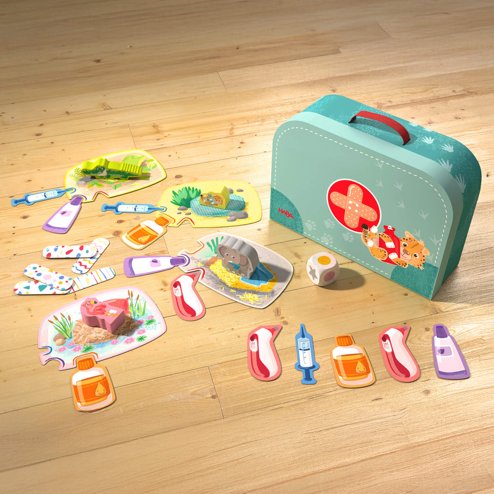 Cardboard suitcase, game boards and wooden figures from the Let's Be Veterinarians game by HABA.