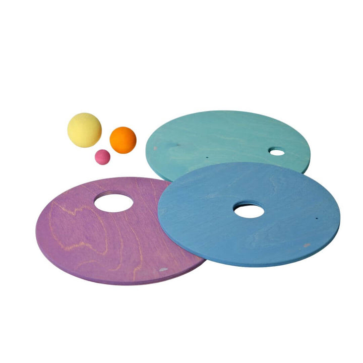 3 wooden pastel rainbow discs in cool colors with various-sized holes and wooden balls.