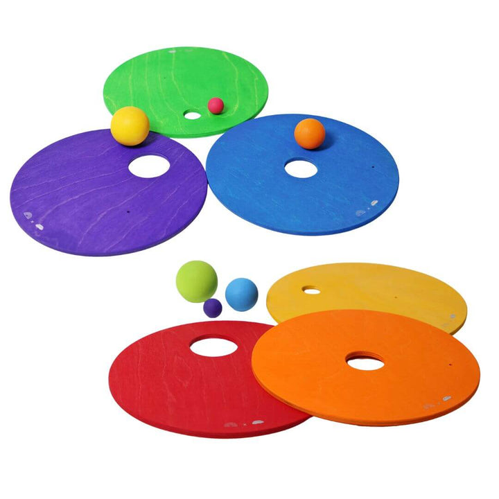 Grimm's x Stapelstein Rainbow disc building toys in primary colors.