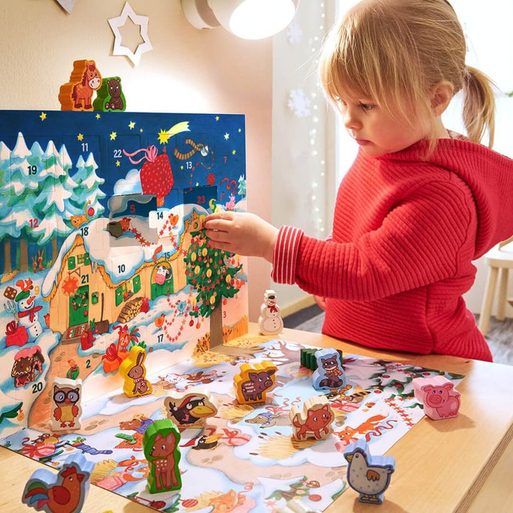 A child opening the Farmyard Animals My First Advent Calendar from HABA.