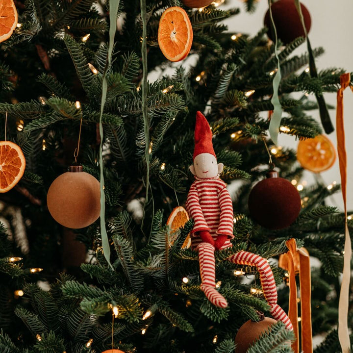 Maileg Long Legged Pixy sitting in a Christmas tree.