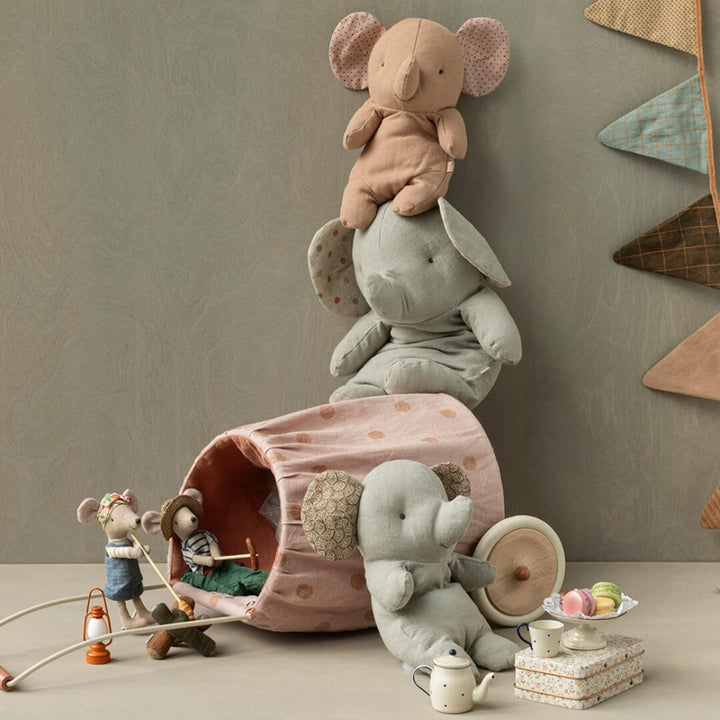 Maileg medium elephant in gray with a pink elephant on its head. Sitting amongst other Maileg toys.