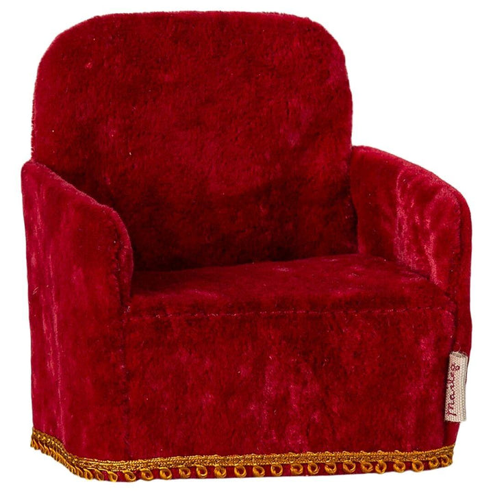 Maileg folding mouse sized arm chair in red with gold accent on bottom.