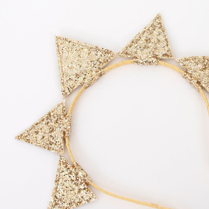 Close detail of the golden star headband with glitter.