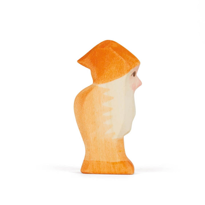 Side view of the orange Ostheimer wooden dwarf figure.