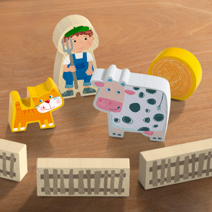 Closeup of wooden pieces of Farmer, Cow, Cat, Hay, and 3 Fences