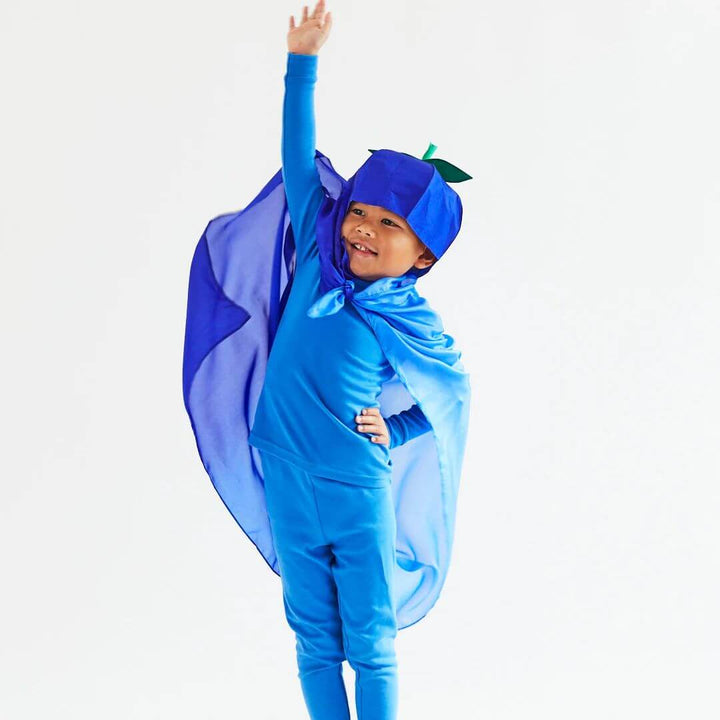 A child wearing a blueberry costume has the blueberry playsilk tied around their neck like a cape.