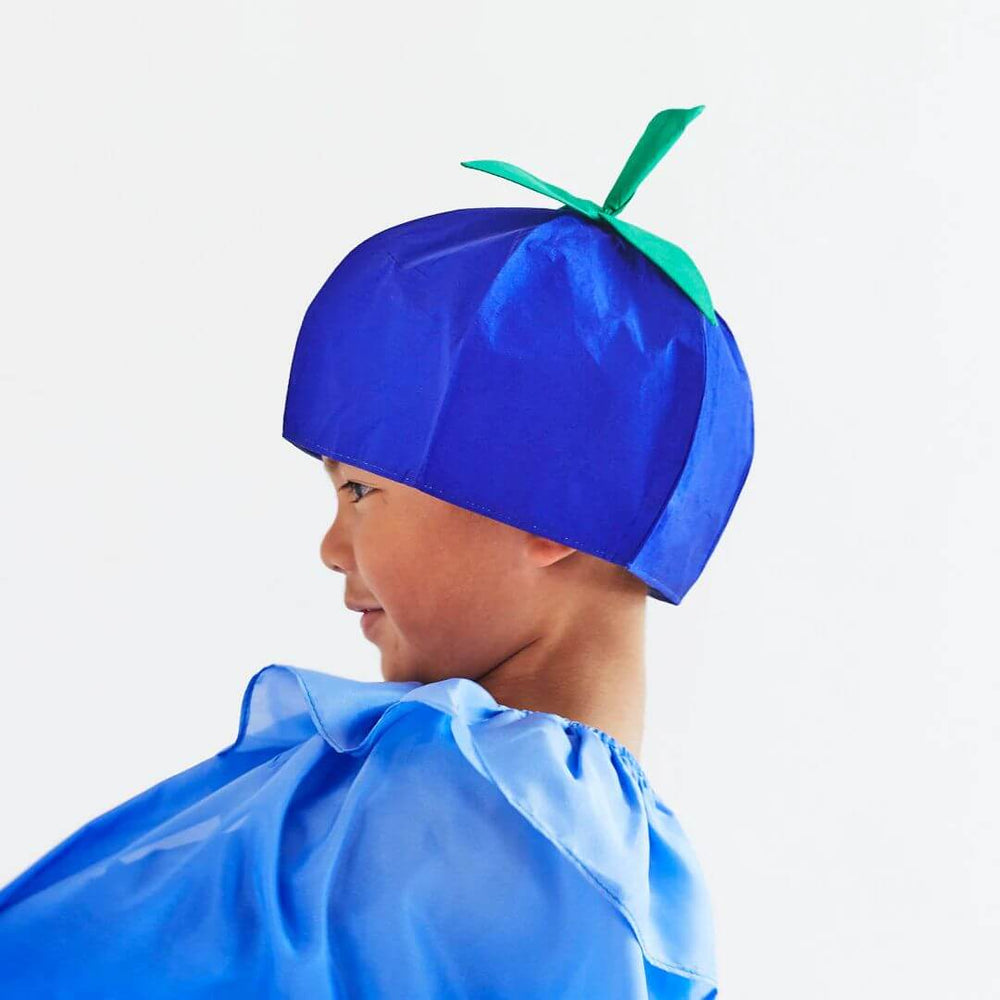 A child's side profile. They are wearing the blue and green silk blueberry hat from Sarah's Silks