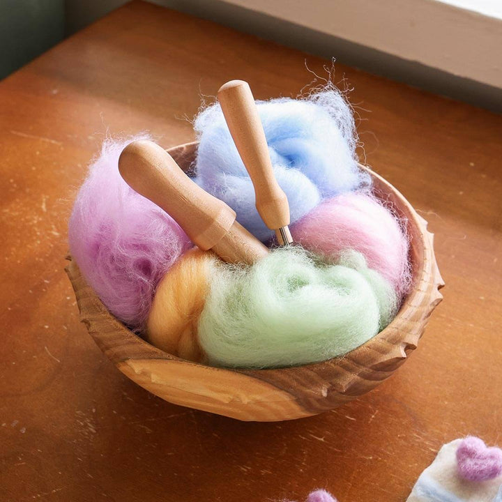 Wool roving in a wooden bowl.